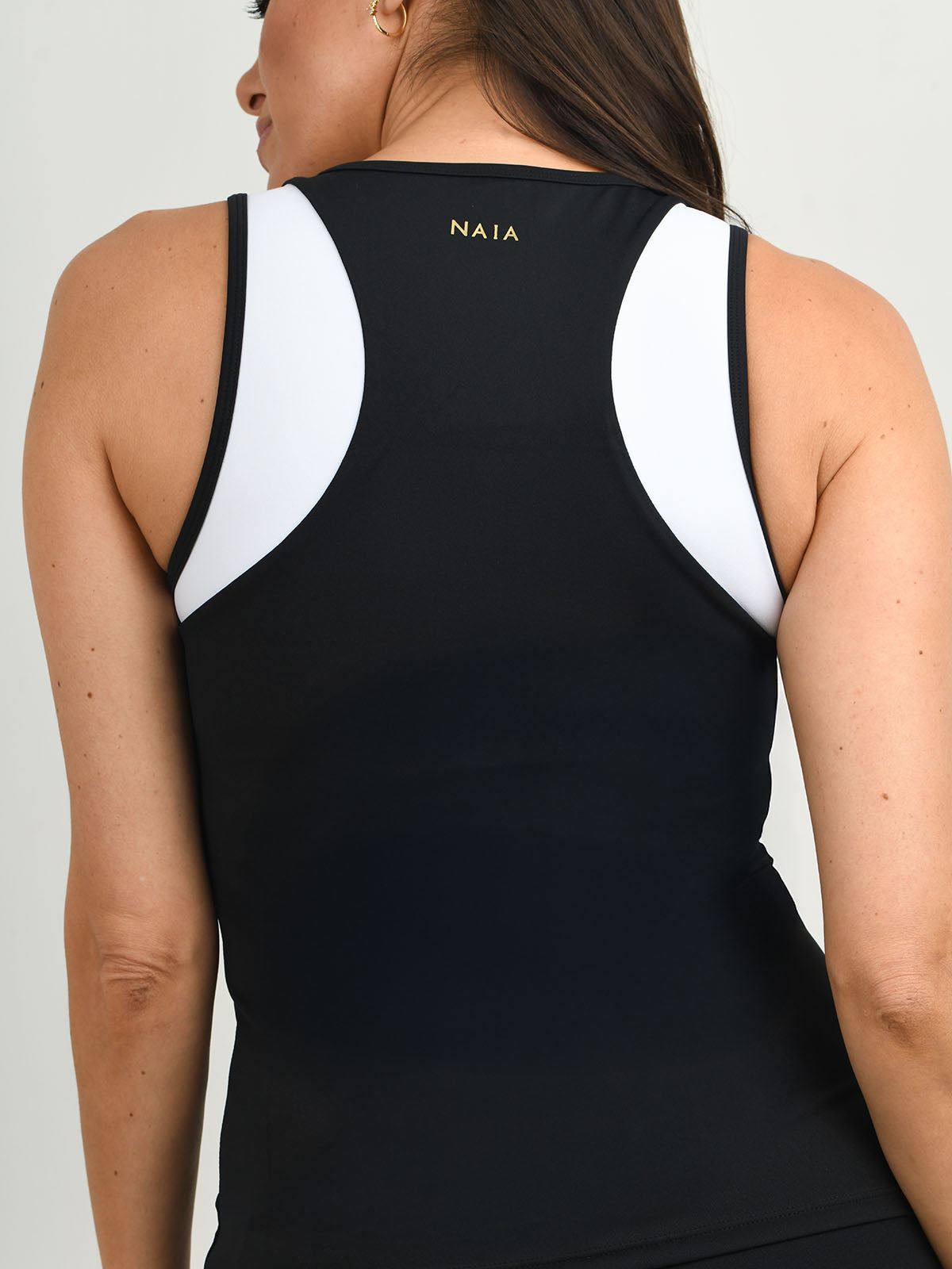 Billie Tipped vest worn with the Billie legging in black with white piping detail from NAIA Active active wear collection