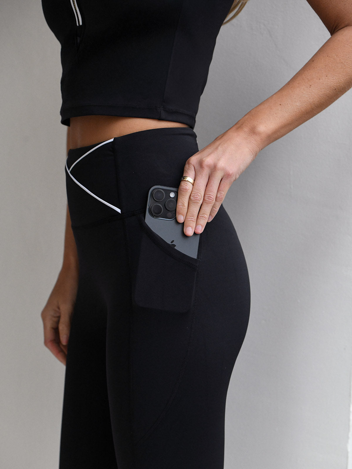 Billie Tipped bra top worn with the Billie legging in black with white piping detAil from NAIA Active active wear collection