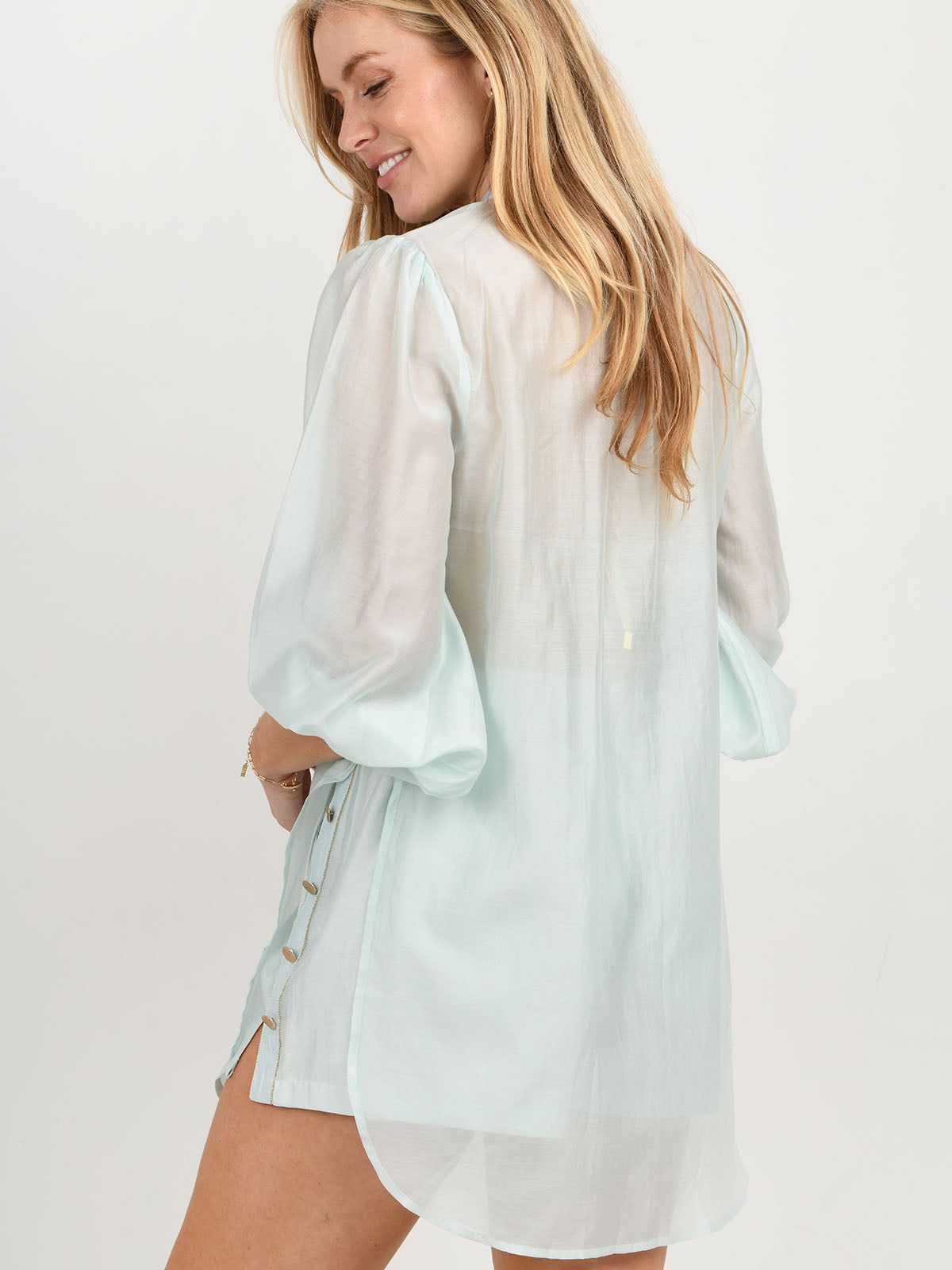 Model wearing the Martinique beach shirt and shorts in aqua by NAIA Beach 