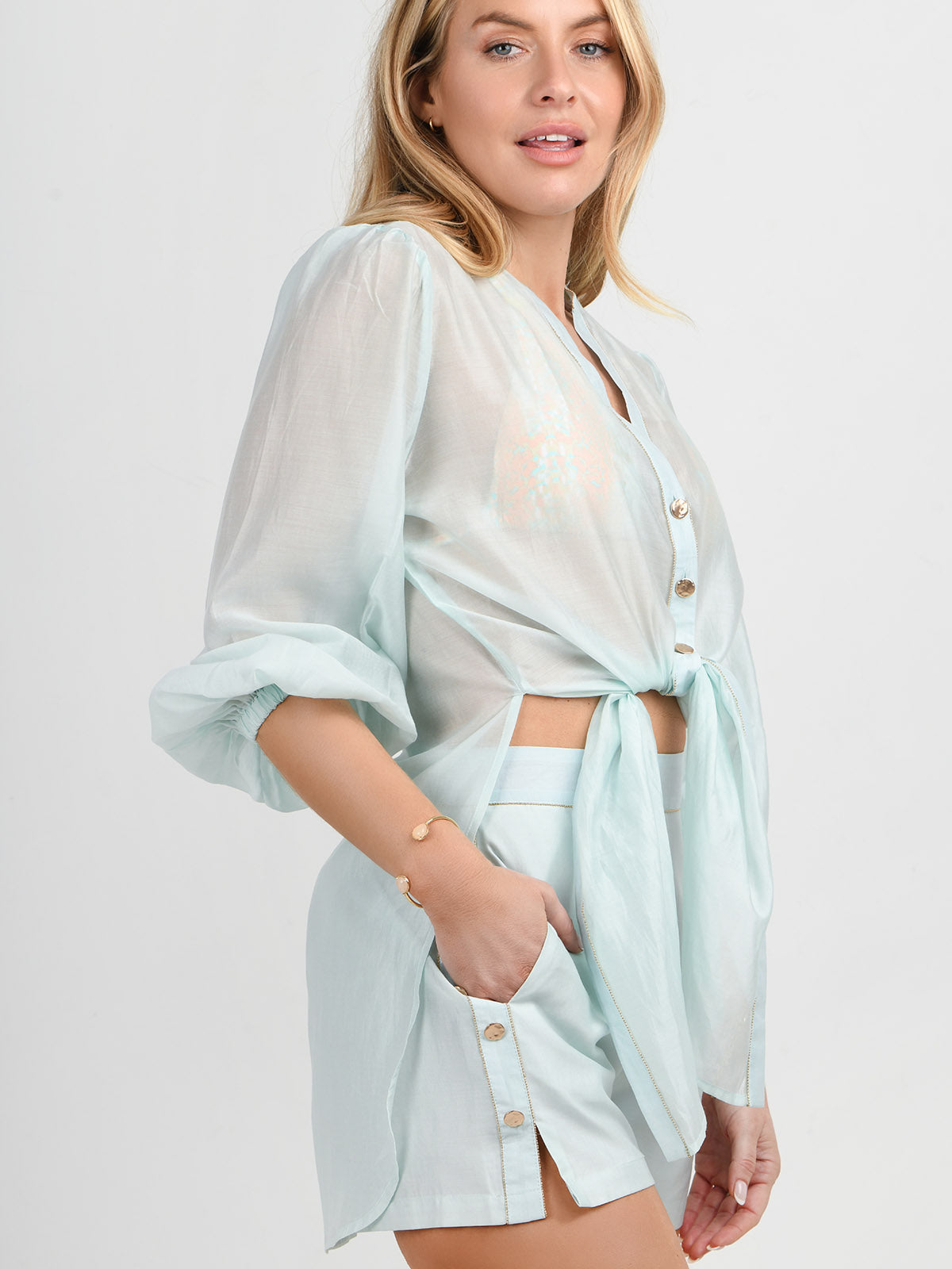 Model wearing the Martinique beach shirt and shorts in aqua by NAIA Beach 