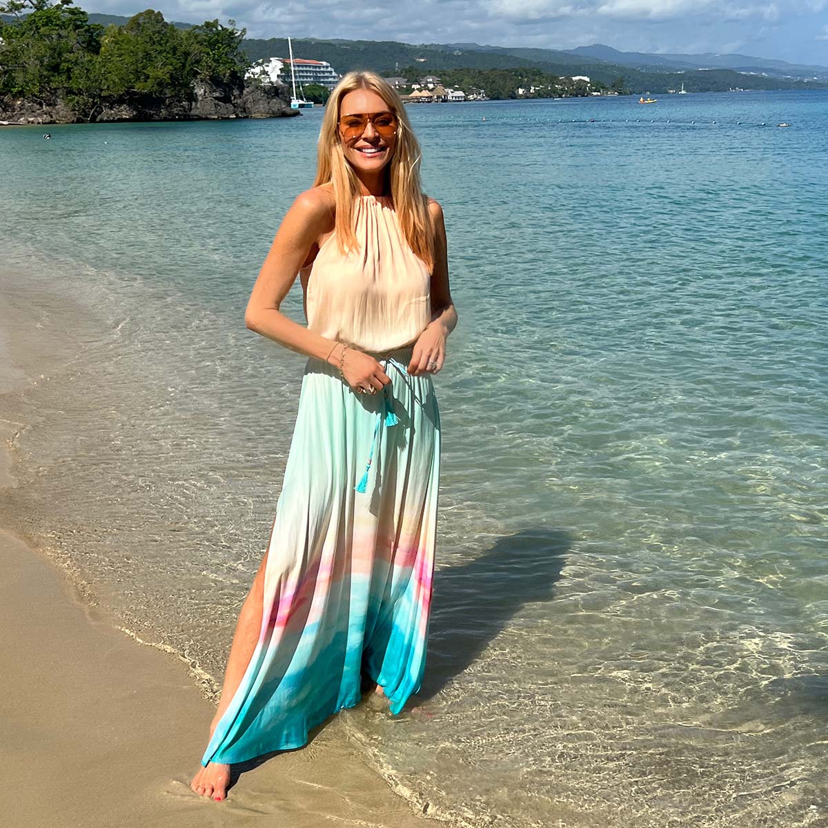 Tess Daly on a beach in the Pelosa Dress by NAIA beach 