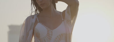 Models at sunset, golden hour on a beach wearing NAIA Beach